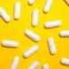 White NAC capsules with yellow background. Photo by Anna Shvets
